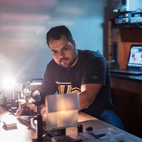 UCF student working on a photonics experiment